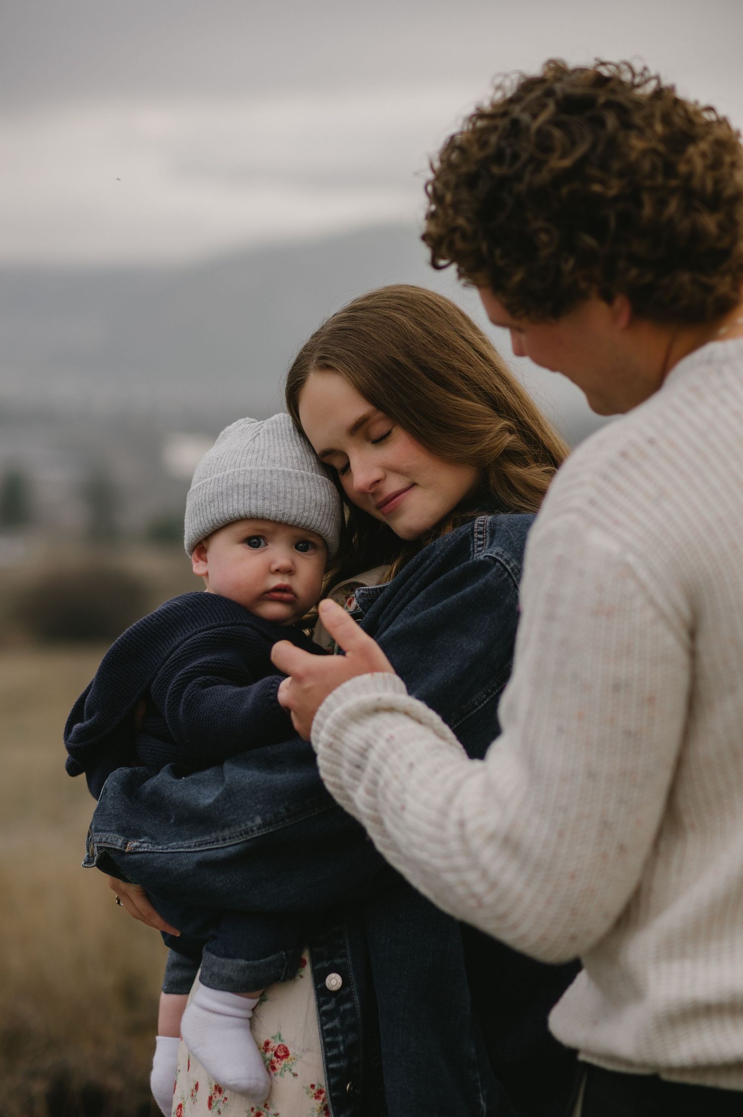 family with baby hugging