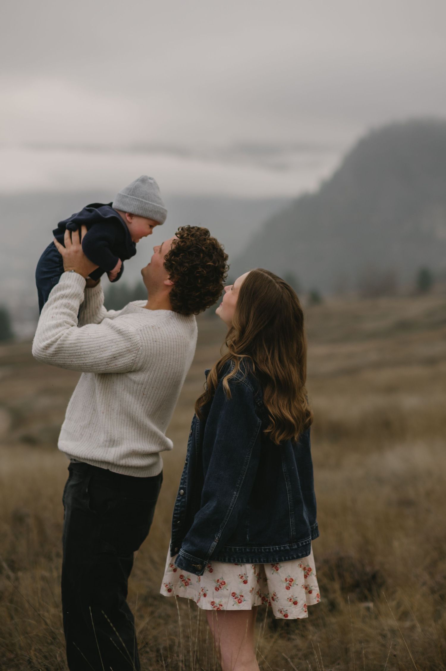 family with baby outside playing