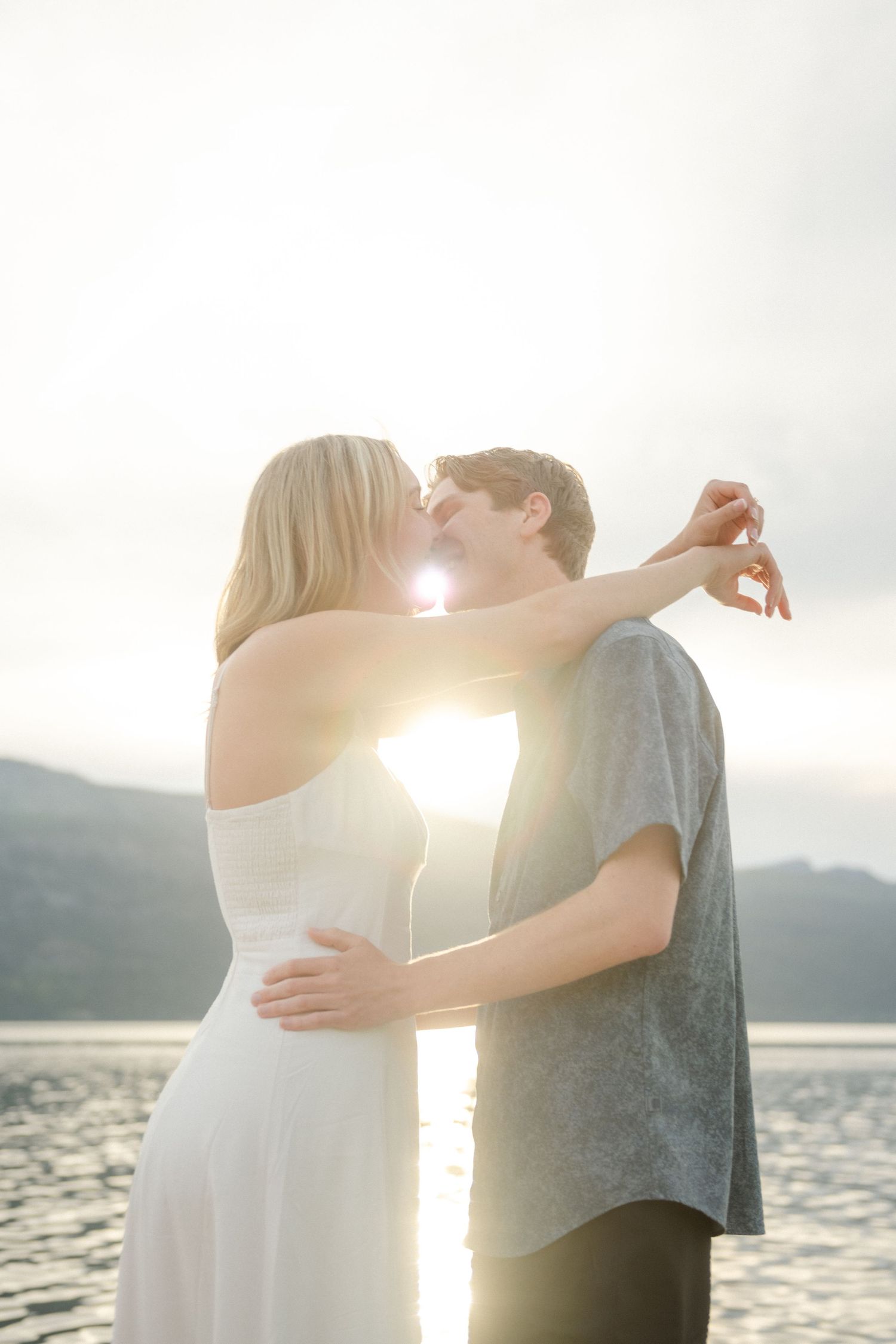 couple kissing by the lake
