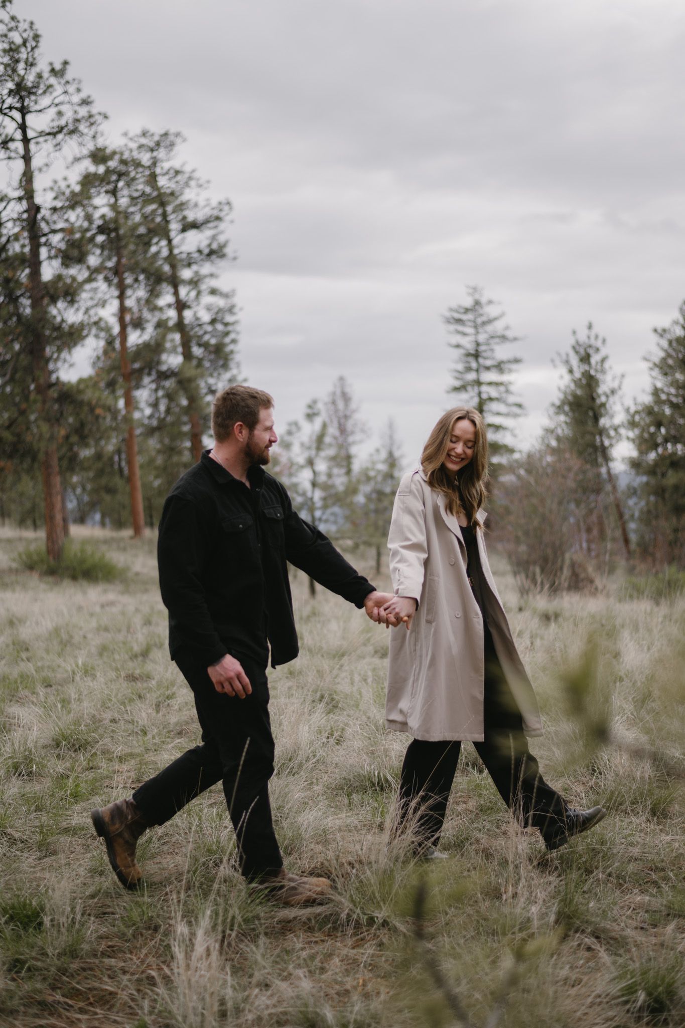 couple holding hands and walking in nature