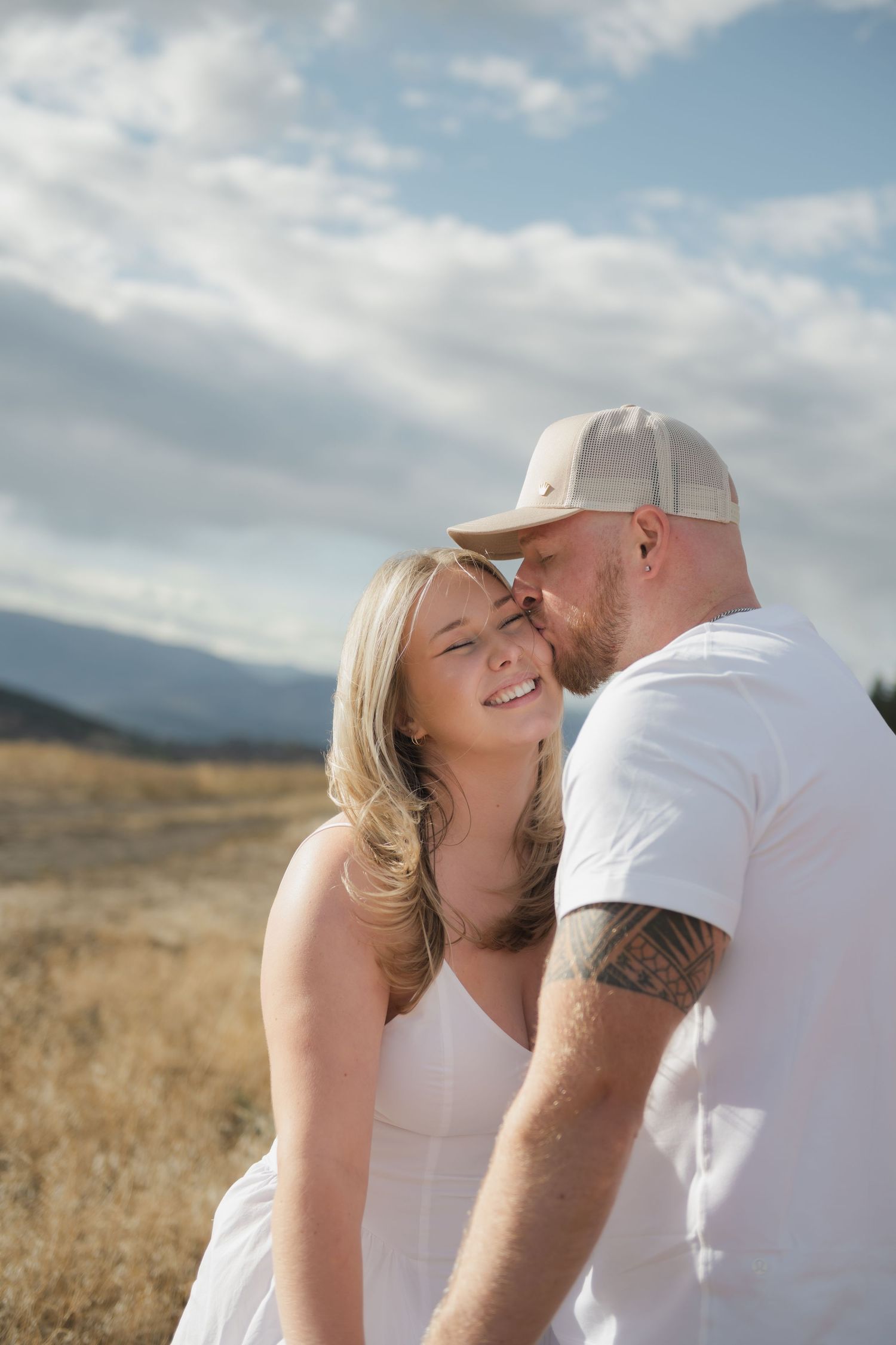 couple kissing on a mountain