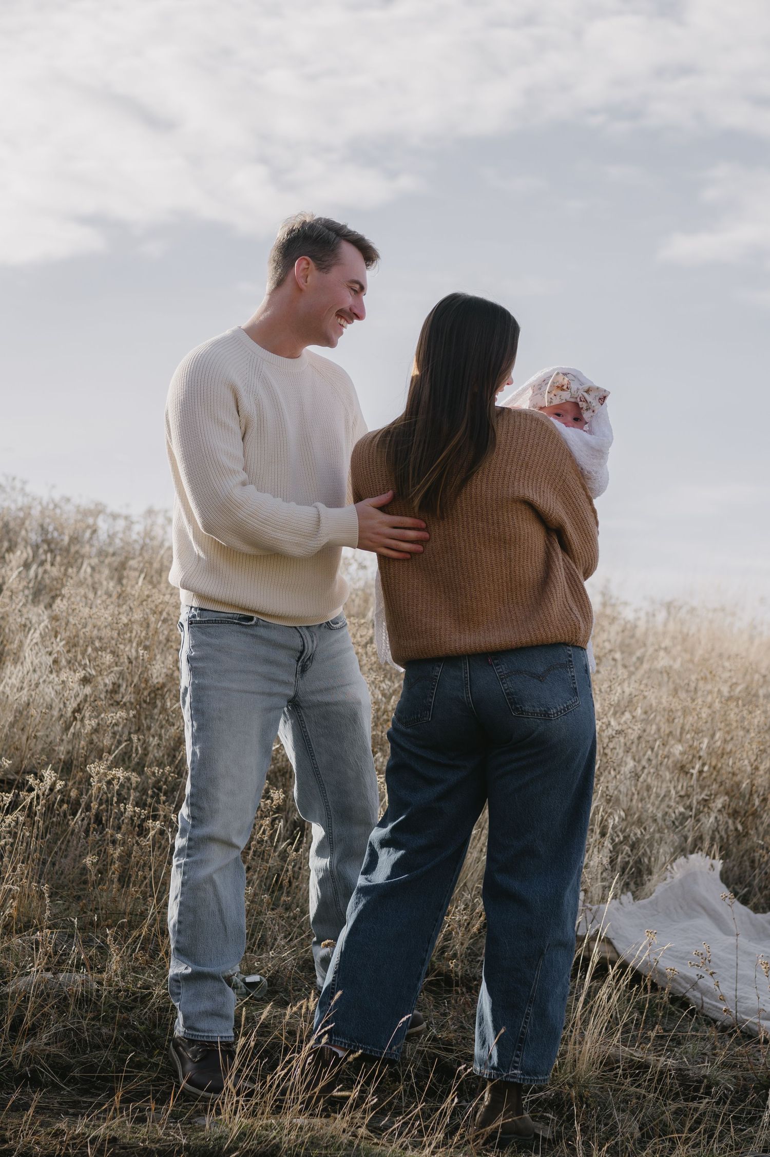 family with baby outside in the sun