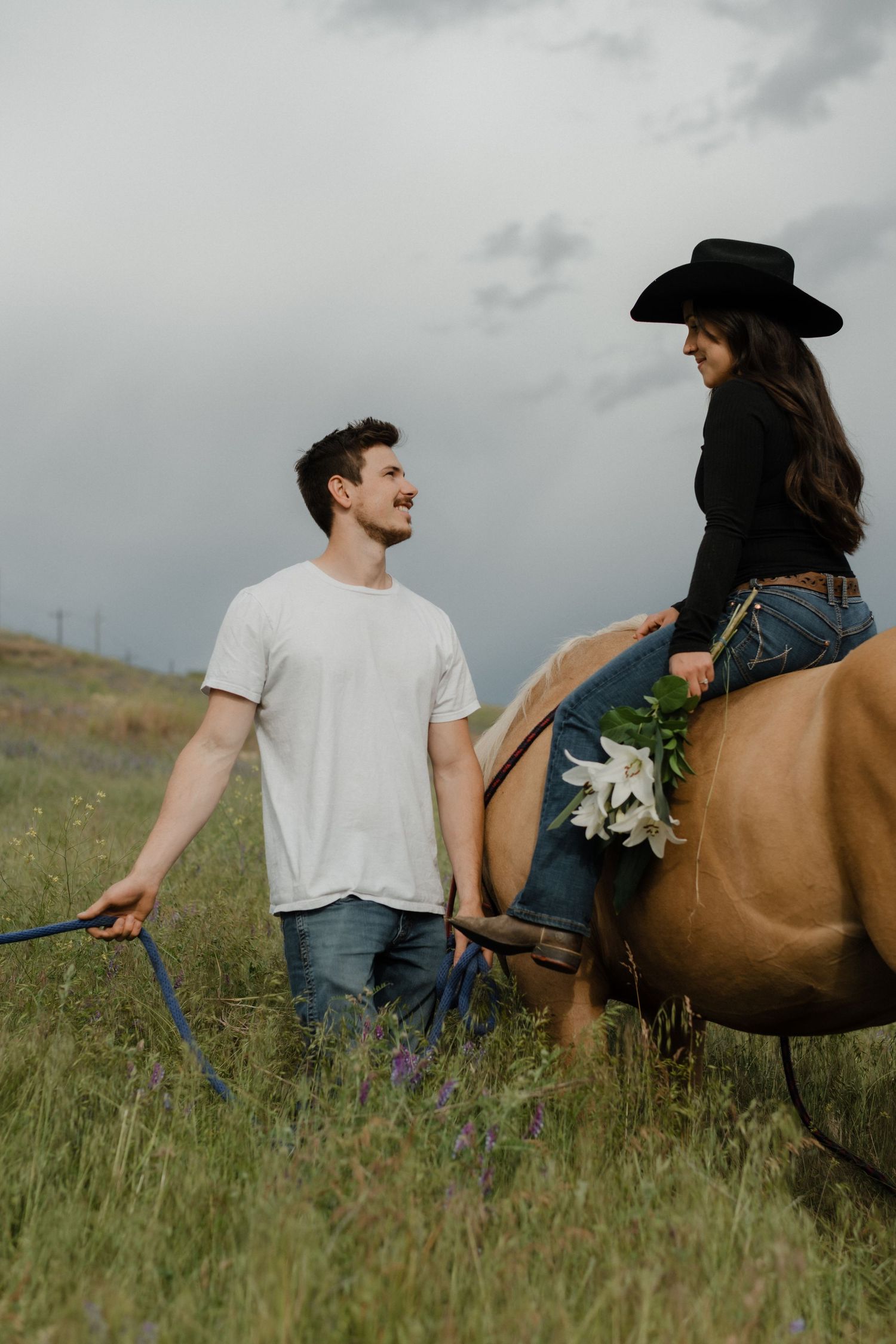 women riding a horse and looking at her husband