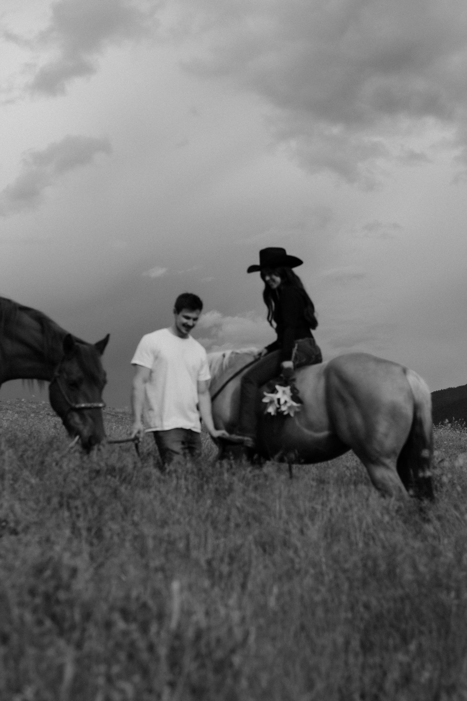 women riding a horse in a field with husband