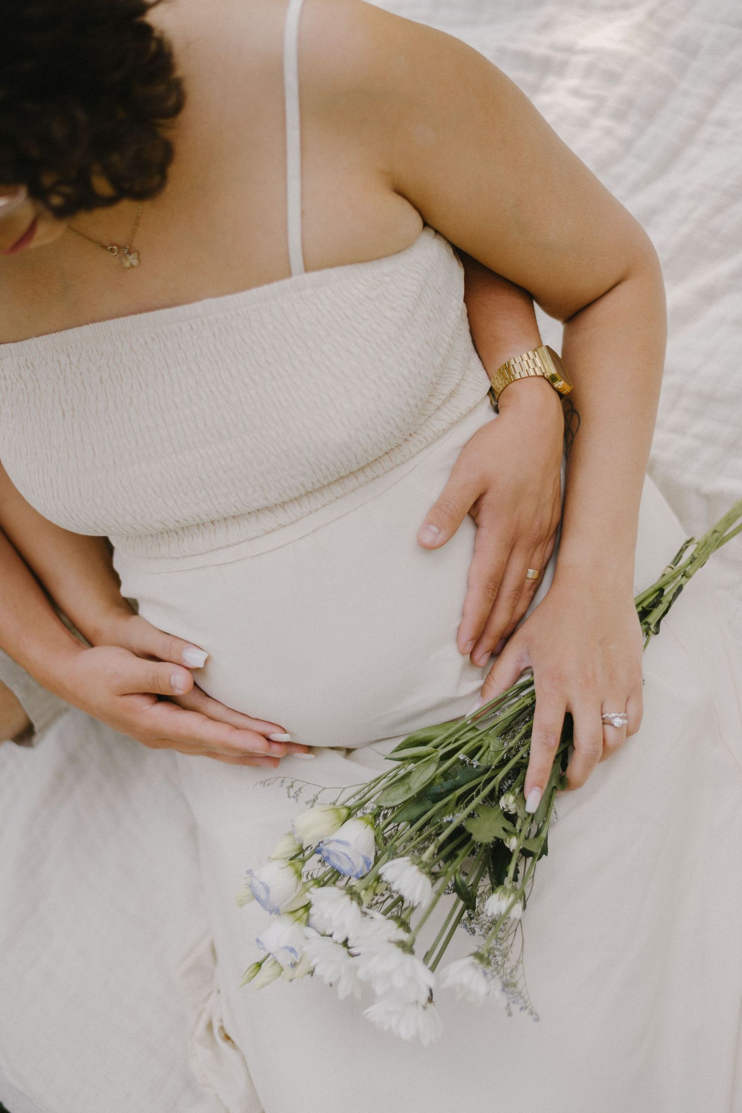 pregnant women holding flowers