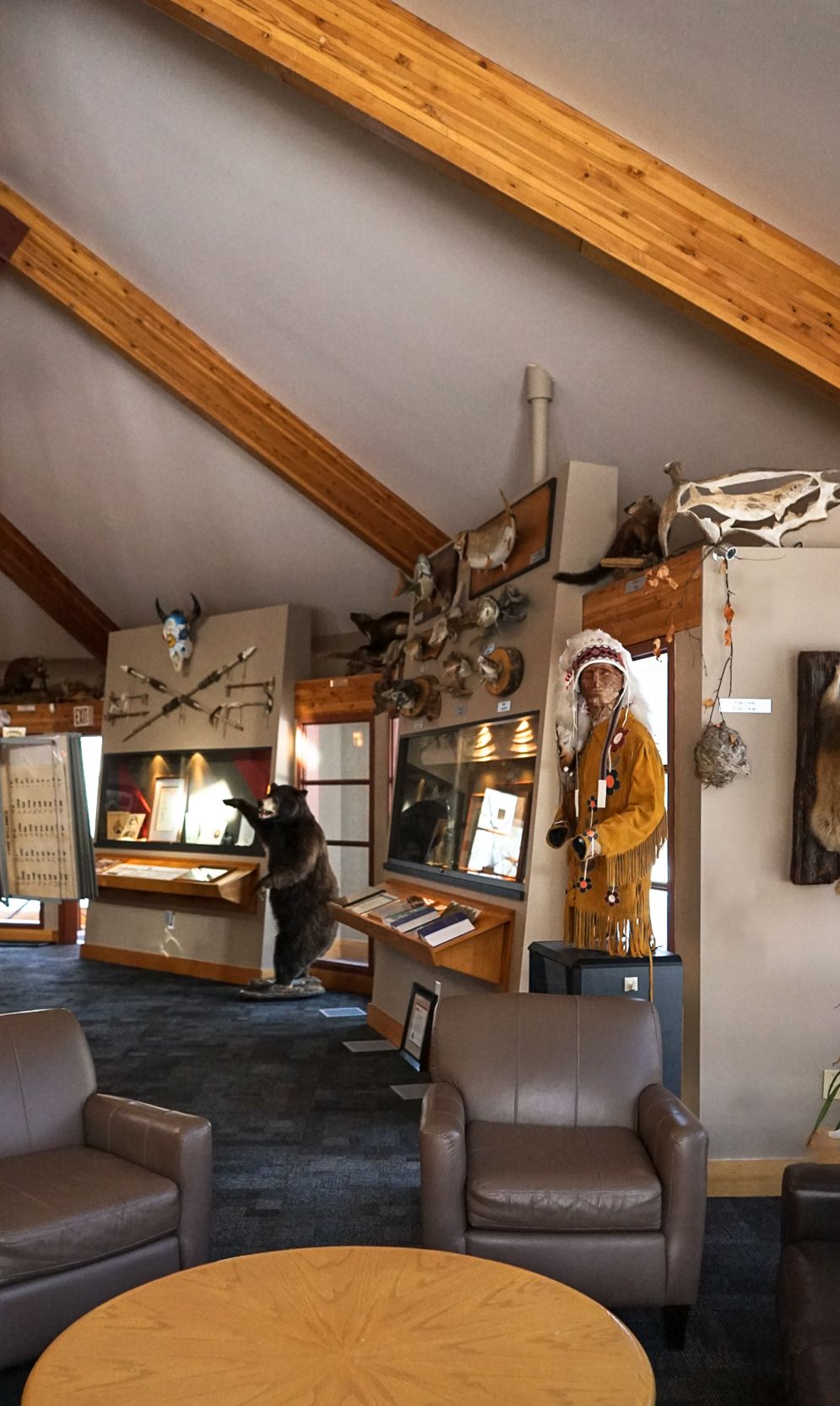 Rustic lodge interior with mounted antlers and wooden beams decorating the walls.