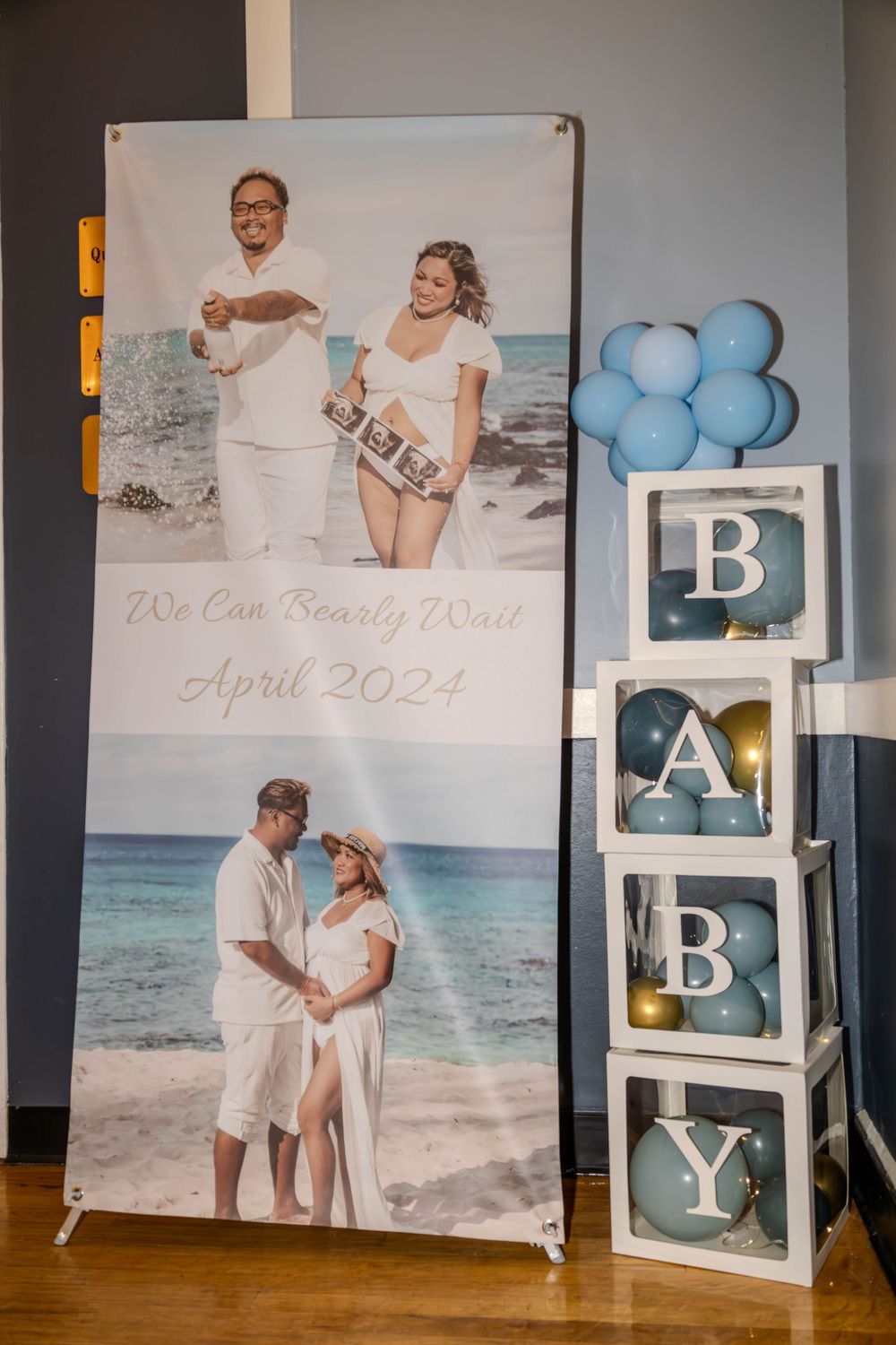 Beach-themed photo display with blue and white decor showing coastal engagement photos.