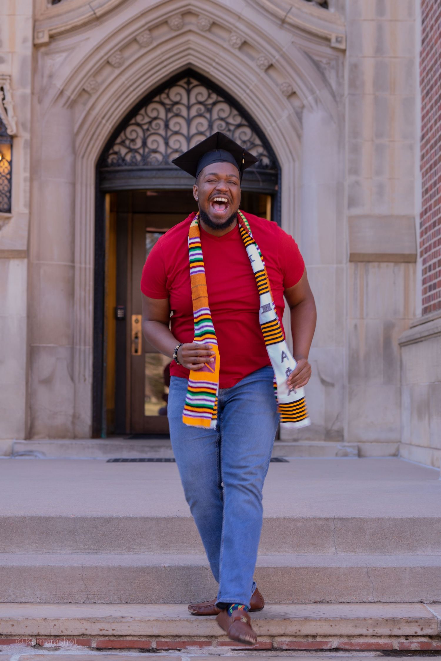 Black graduate celebrating with cap and Frat at outdoor Denver location – captured by KamaraImages