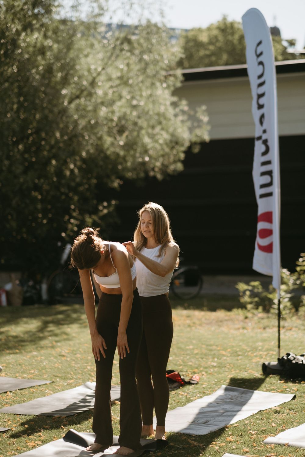 a yoga teacher offering guidance to yoga event participant during yoga photoshoot in Stockholm