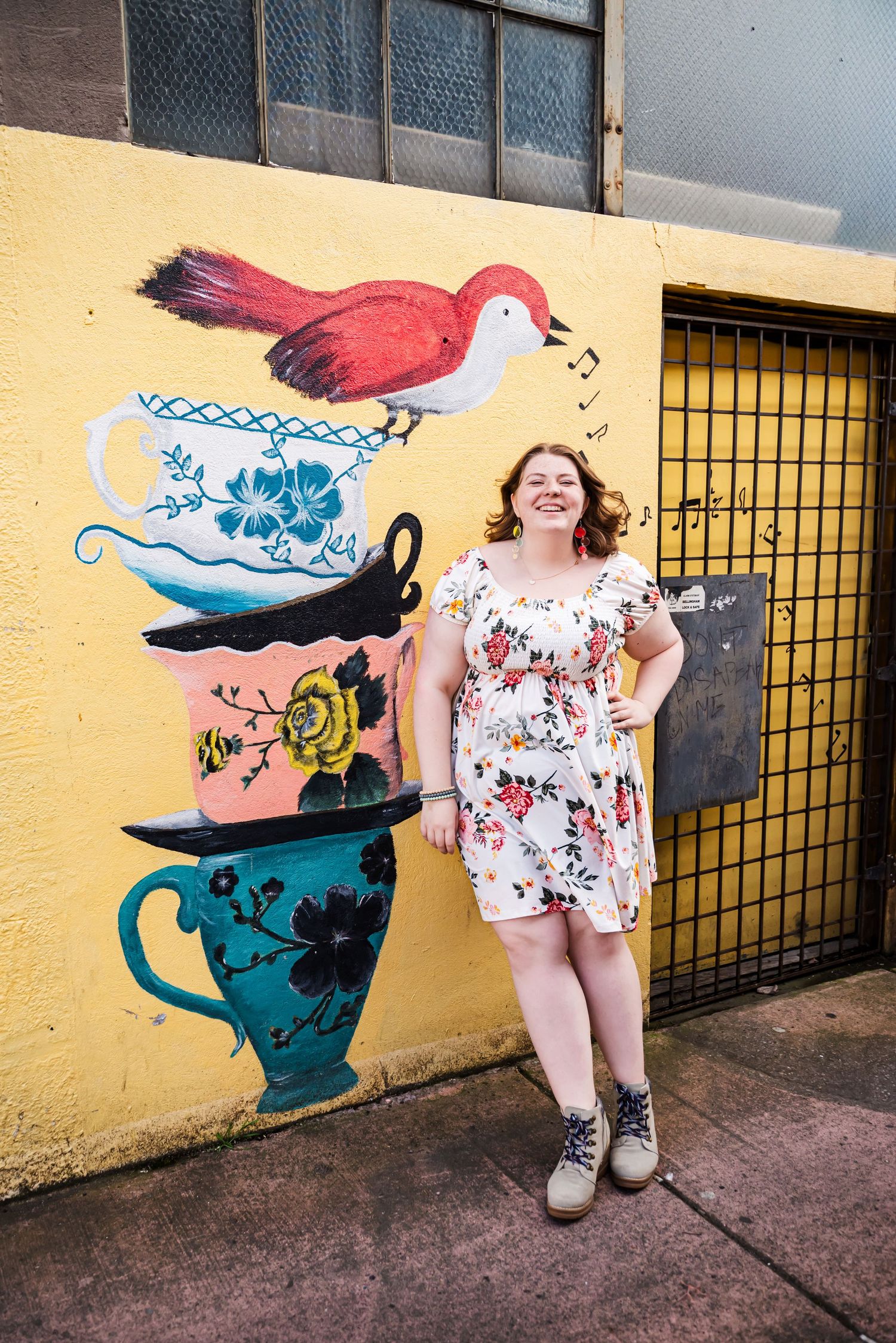 senior girl smiling sassy by a mural downtown Mount Vernon, Skagit