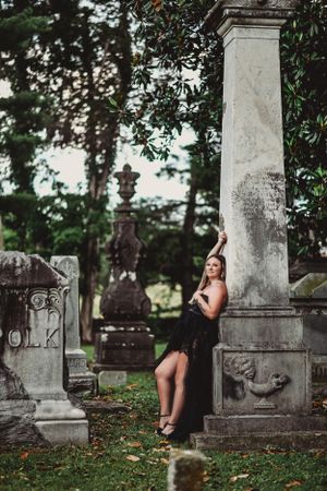 Historic cemetery with ornate stone monuments and lush greenery.