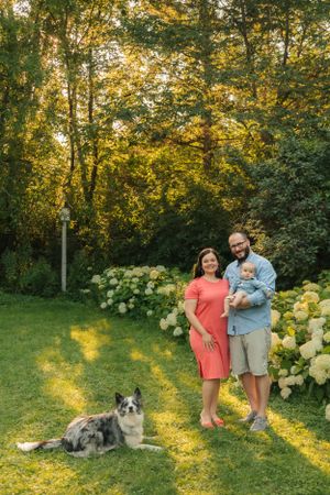 An outdoor family portrait with cat and dog