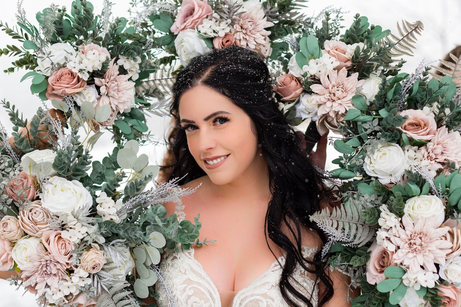Floral arrangement with pink roses and greenery creates a romantic backdrop.