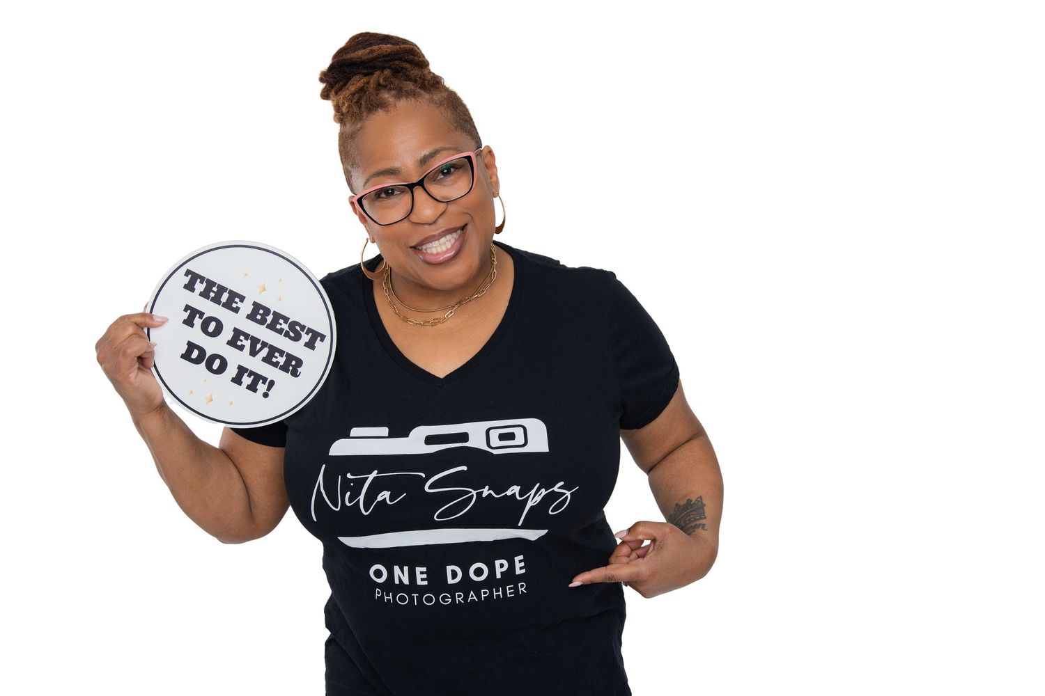 Professional wearing glasses and dreadlocks gives thumbs up against white background.