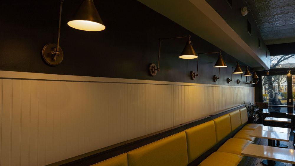 A coffee shop with lights on the wall