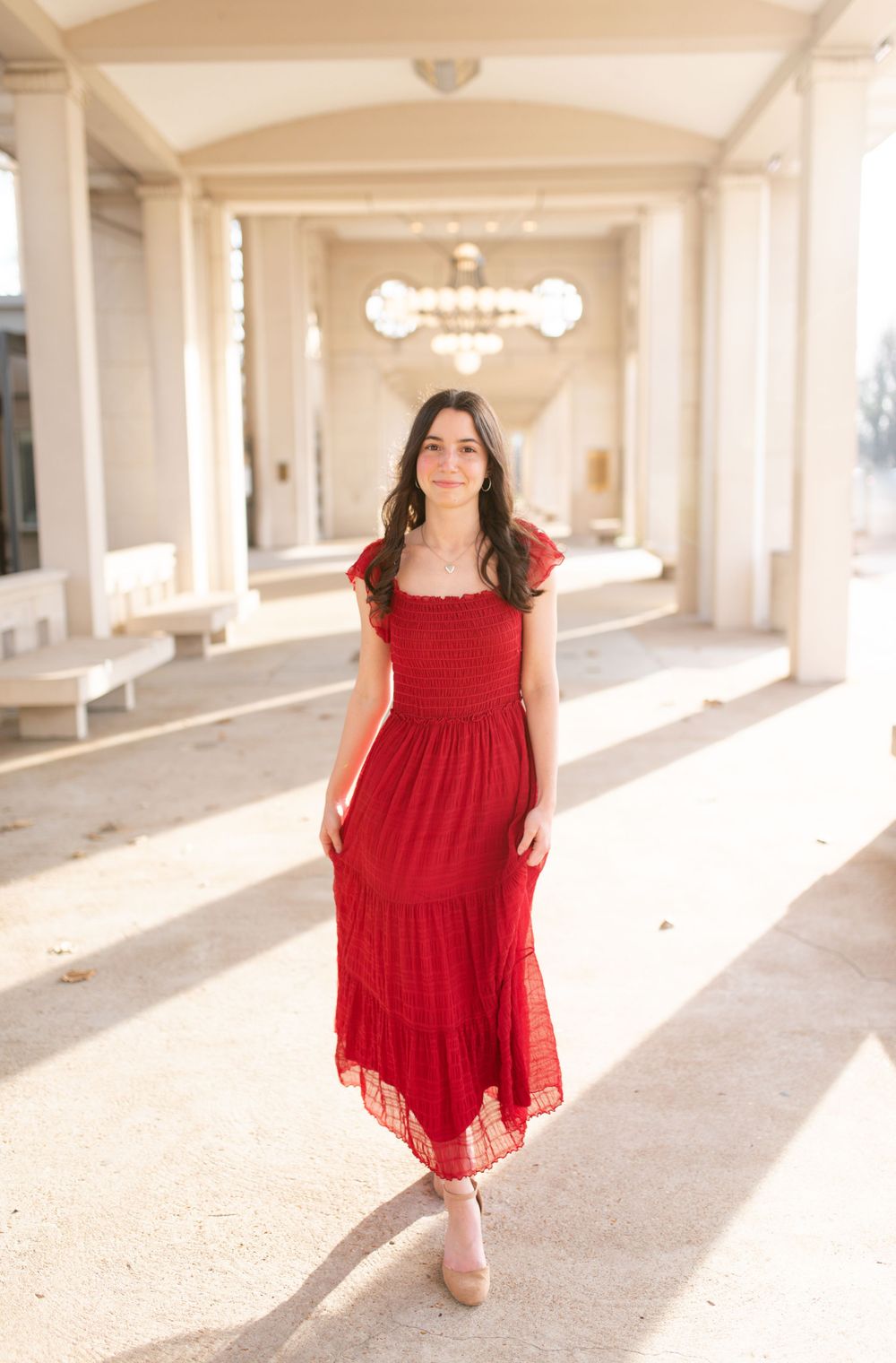 Senior standing outdoors during golden hour photos in O’Fallon MO