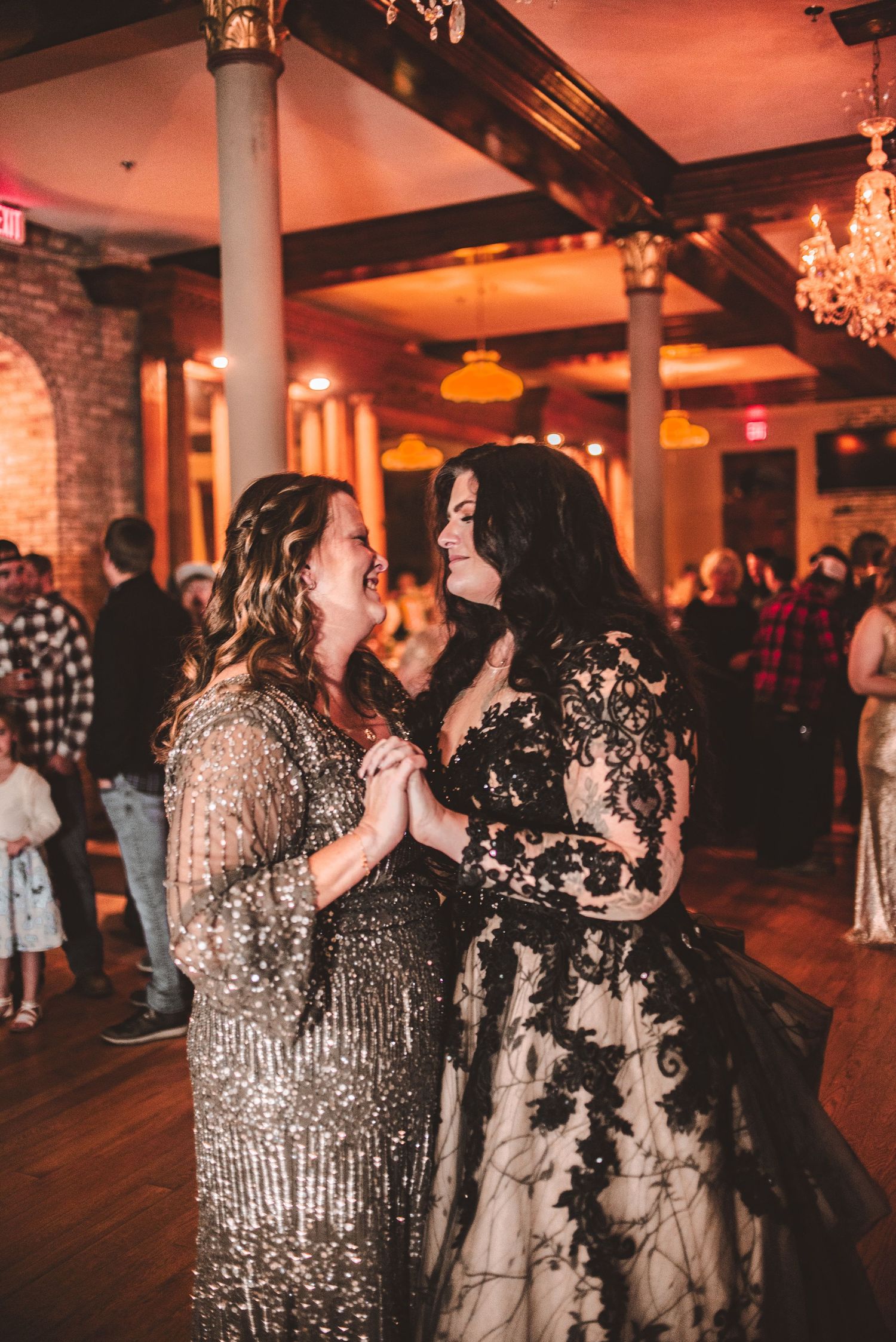 Two people sharing a glamorous dance moment in sparkling formal attire.