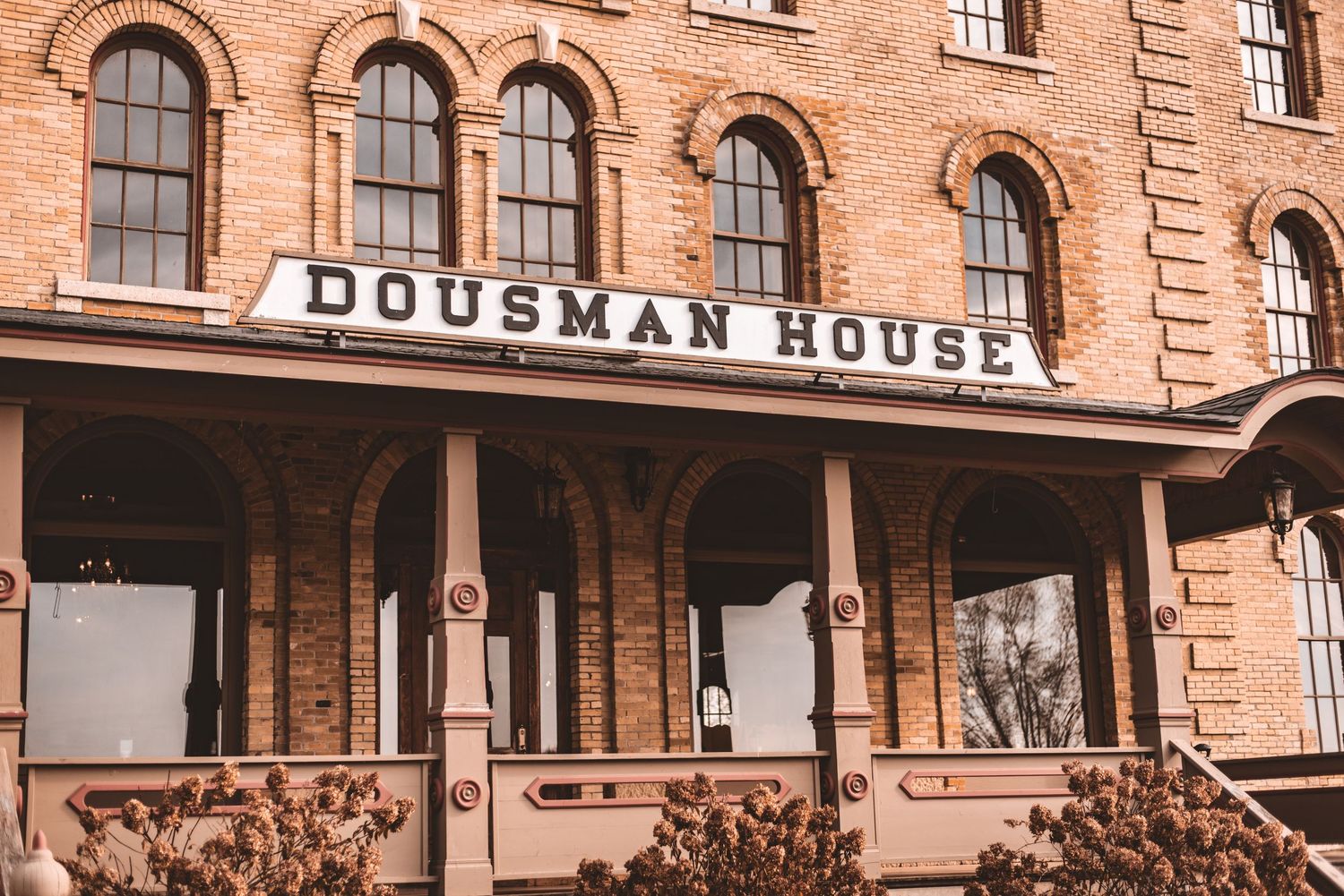 The historic Dousman House building exterior with its distinctive brick facade and arched windows.