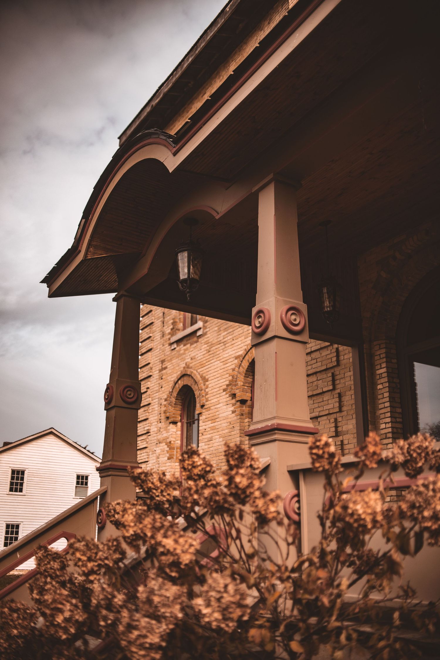 Detailed architectural elements of the Dousman House showing curved eaves and decorative columns.