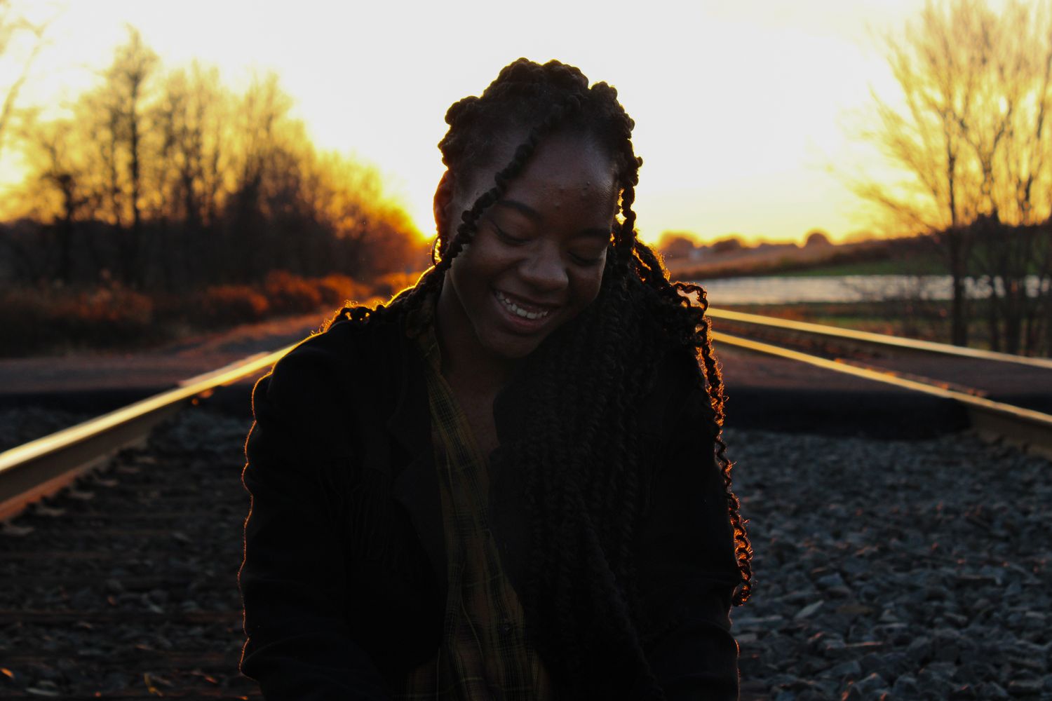 backlit portrait of a young woman at sunset