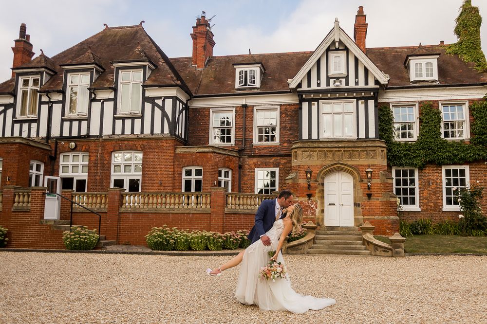 A collage of five exterior shots of a historic Tudor-style mansion with red brick and white trim details.