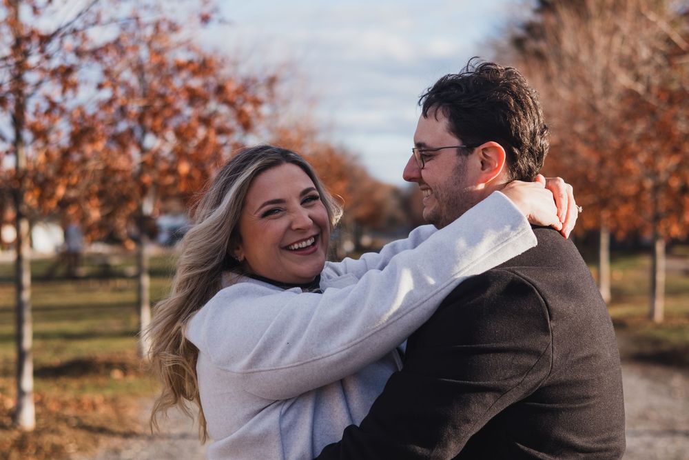Romantic couple portraits in fall setting with warm autumn colors.