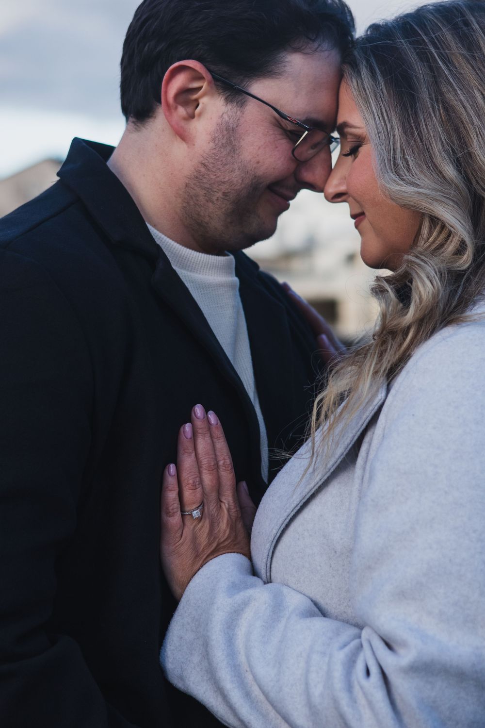 An intimate close-up of a couple sharing a tender moment outdoors.