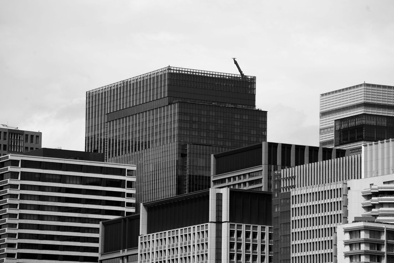 Black and white cityscape showing modern office buildings and parking structures.