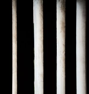 Row of white vertical columns creating a rhythmic pattern against a dark background.