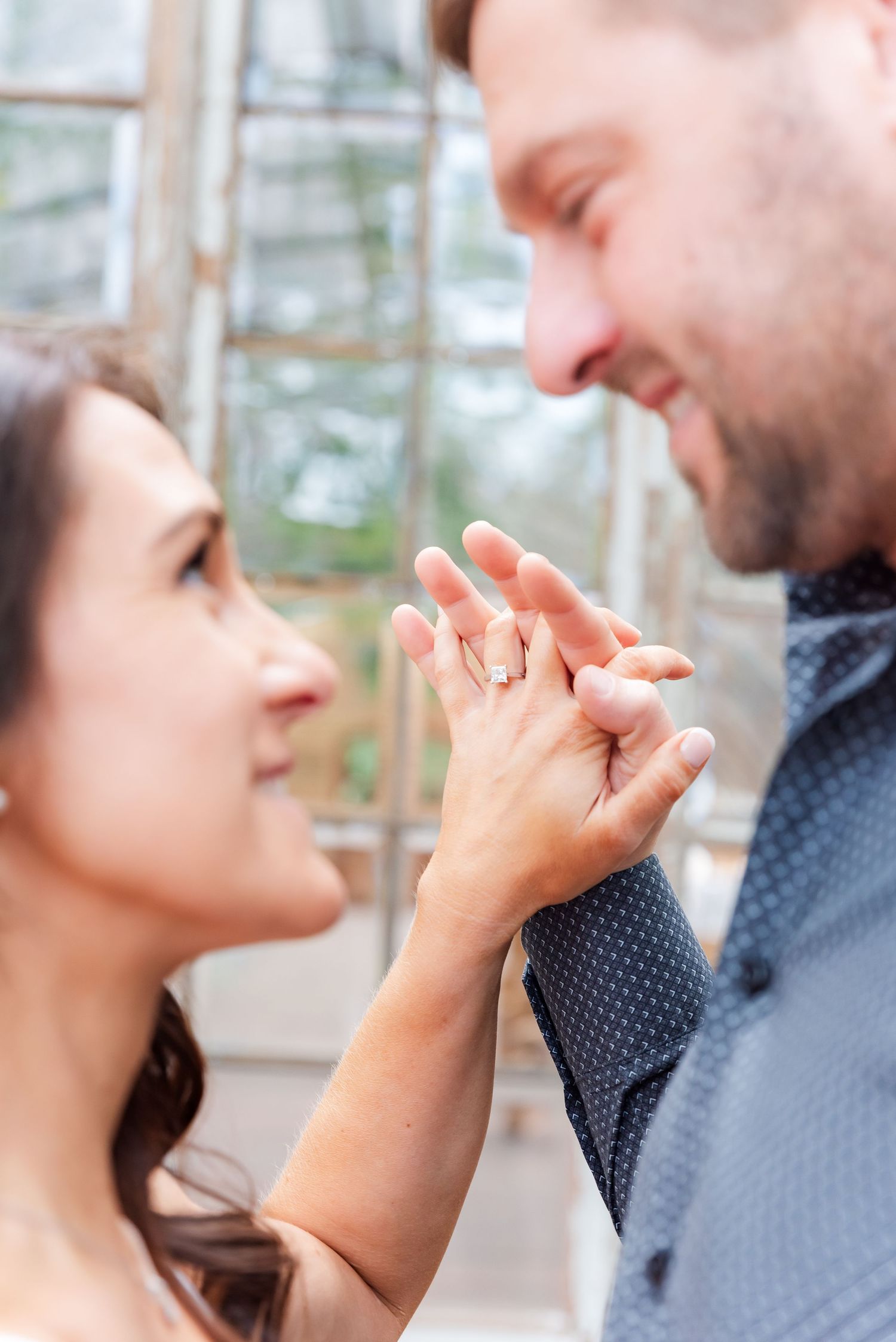 A couple holding hands, focused on the engagement ring. Mayfield, KY
