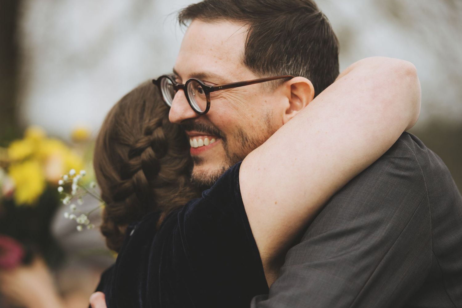 Joyful embrace shared during wedding celebration in church setting.