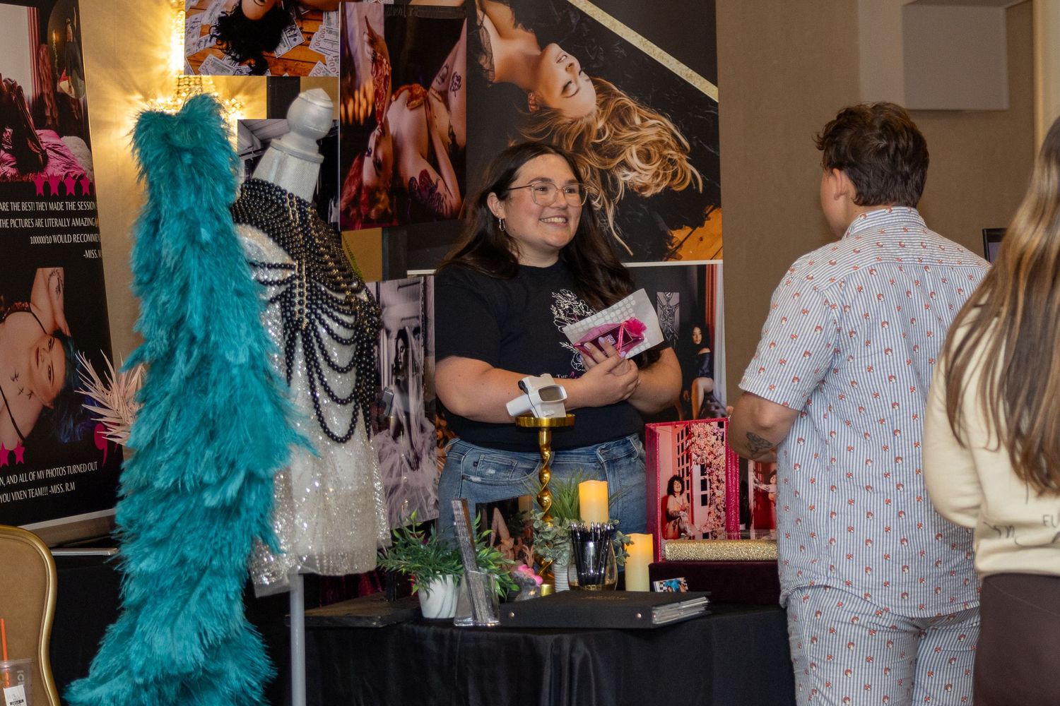 Event attendees browse displays and interact at an indoor gathering with professional lighting.