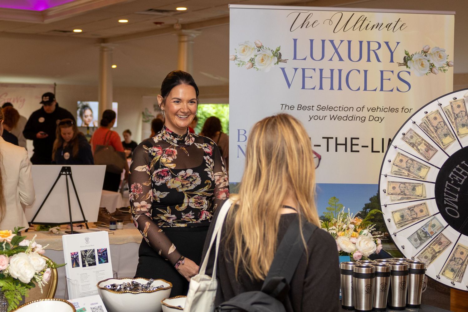 Luxury event setup with branded banners and marketing materials on display tables.