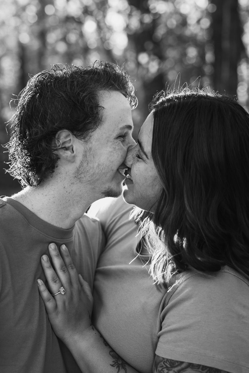 Newly engaged couple embracing in a Snohomish field. Intimate and affectionate engagement photography by Tim Neal.