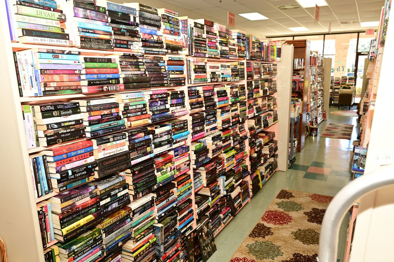 Wide angle view of a well-lit bookstore showing rows of bookshelves and organized displays.