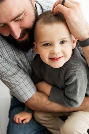 Close up of playful moment between parent and child in casual attire.