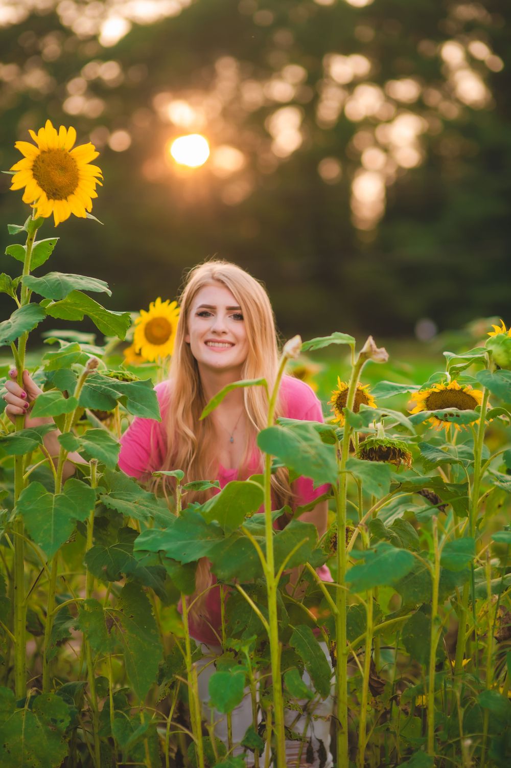 Sunflower field senior session golden hour beautiful girl milestone of life graduating backligt warm colors bokeh