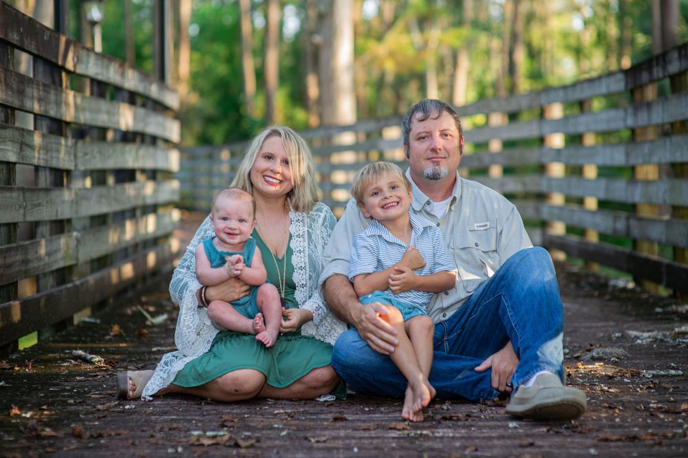 Family session in Florala Alabama shows depth boardwalk bokeh natural light spanish moss on trees laughter smiles memories captured family