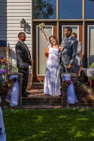 a bride and groom show joy at the alter.