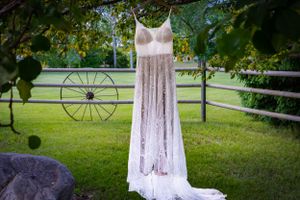 a wedding dress hanging from a tree.
