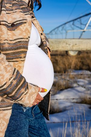 a pregnant woman in a field.