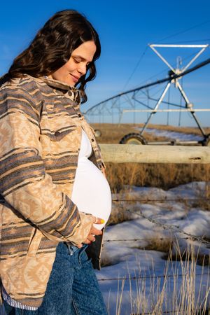 a pregnant woman in a field.