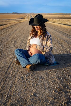 a pregnant woman in a field.