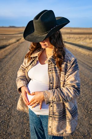 a pregnant woman in a field.