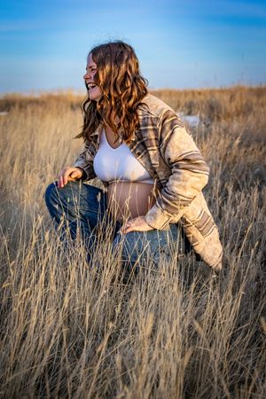 a pregnant woman in a field.