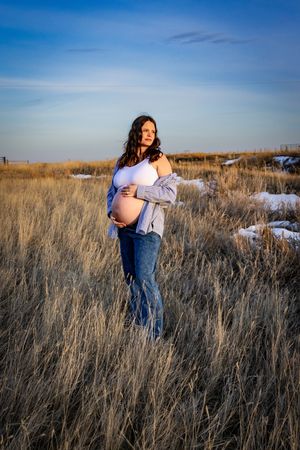 a pregnant woman in a field.