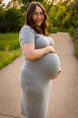 a pregnant woman holding her baby bump.
