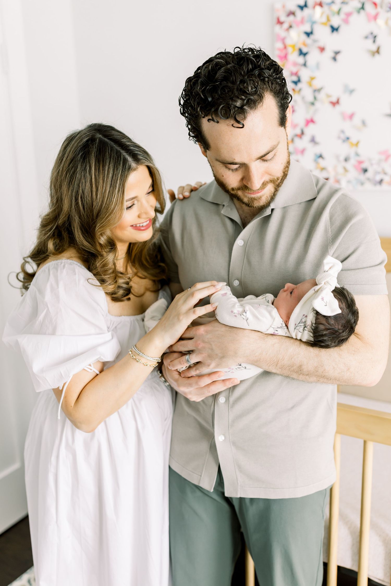 A tender family moment in a nursery with soft natural lighting.