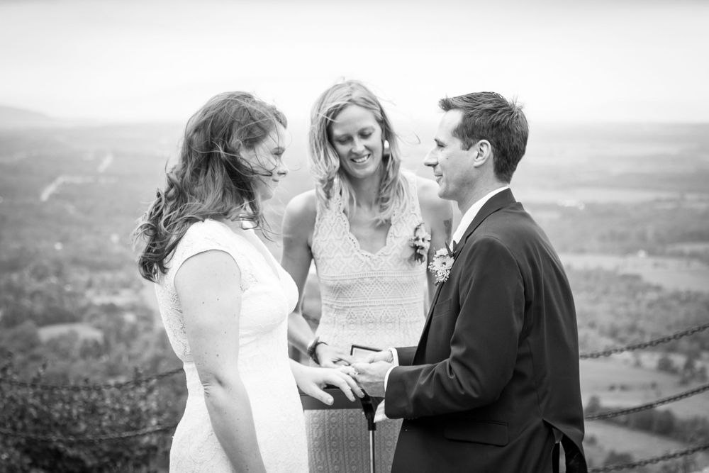 Black and white wedding photography showing candid moments between a couple during an outdoor celebration on Mount Philo in Vermont.