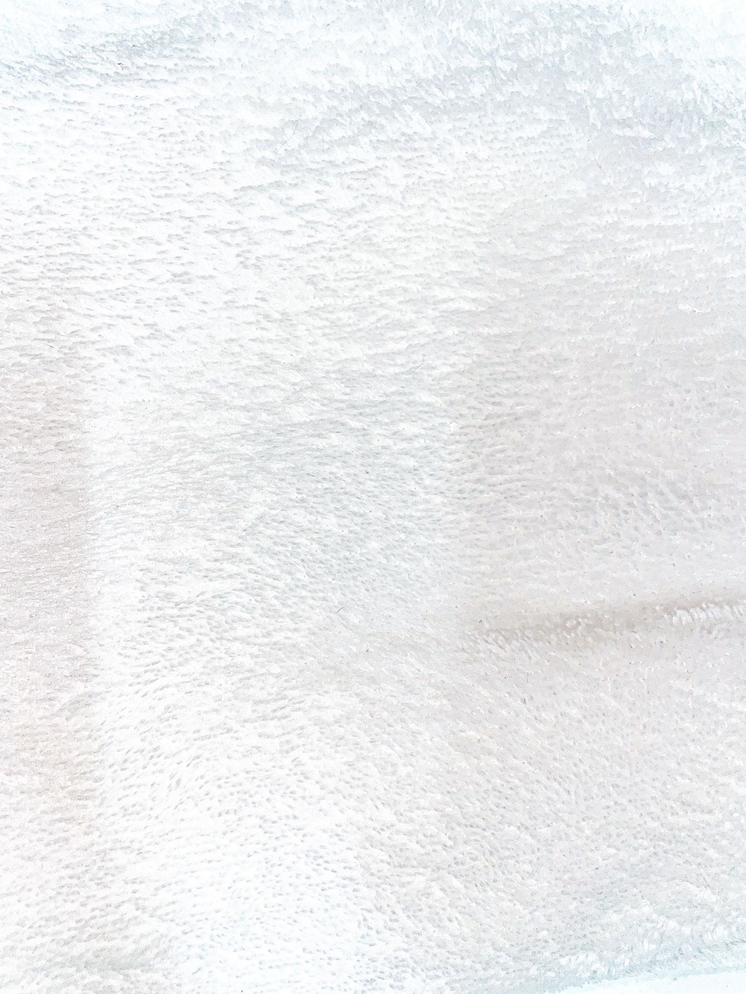 Abstract white textured background with subtle gradient pattern.